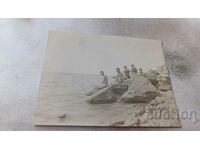 Φωτογραφία Nessebar Νέοι άνδρες και γυναίκες σε βράχους δίπλα στη θάλασσα