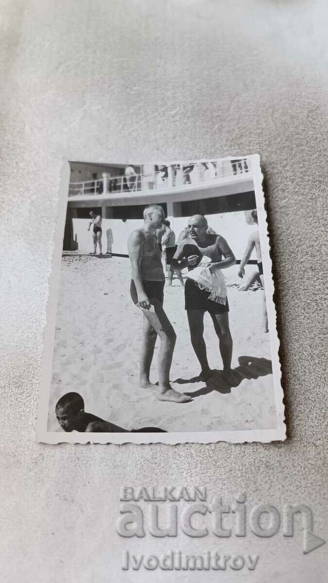 Foto Doi bărbați în costume de baie pe plajă