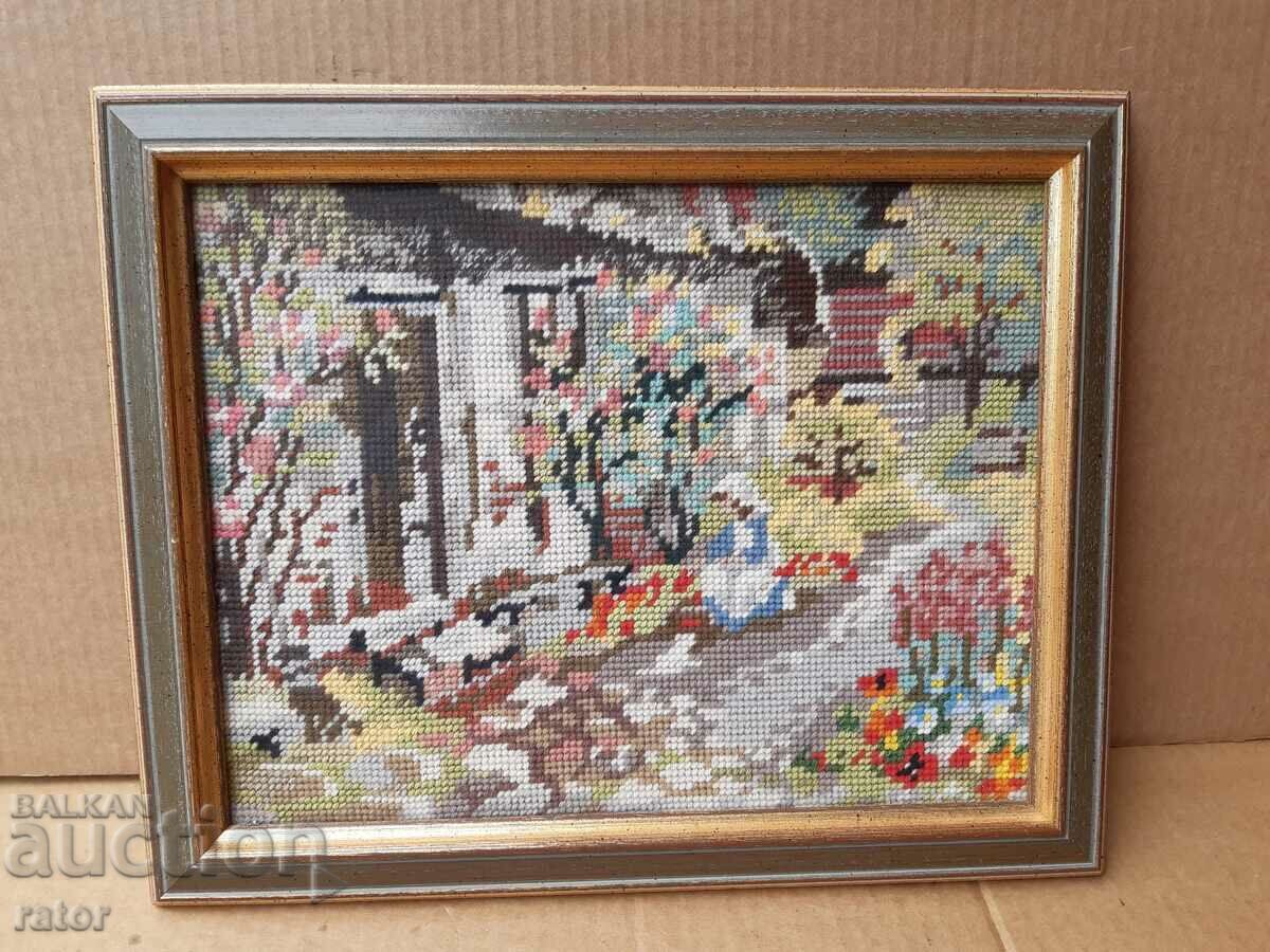 Old hand-stitched tapestry with a beautiful frame