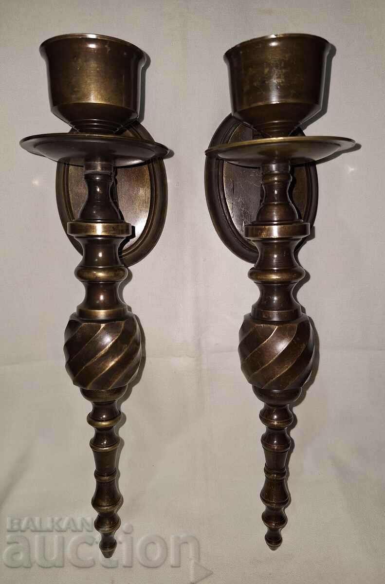 A pair of old bronze wall sconces