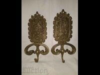 A pair of old bronze wall hangers