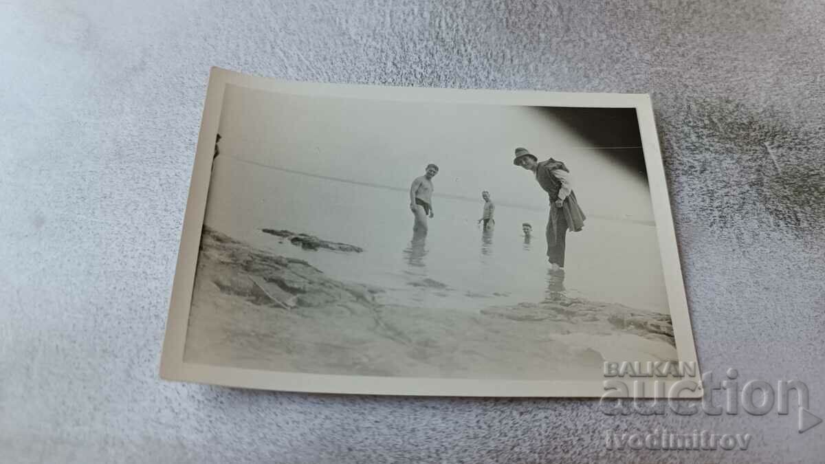 Photo Four men on the beach
