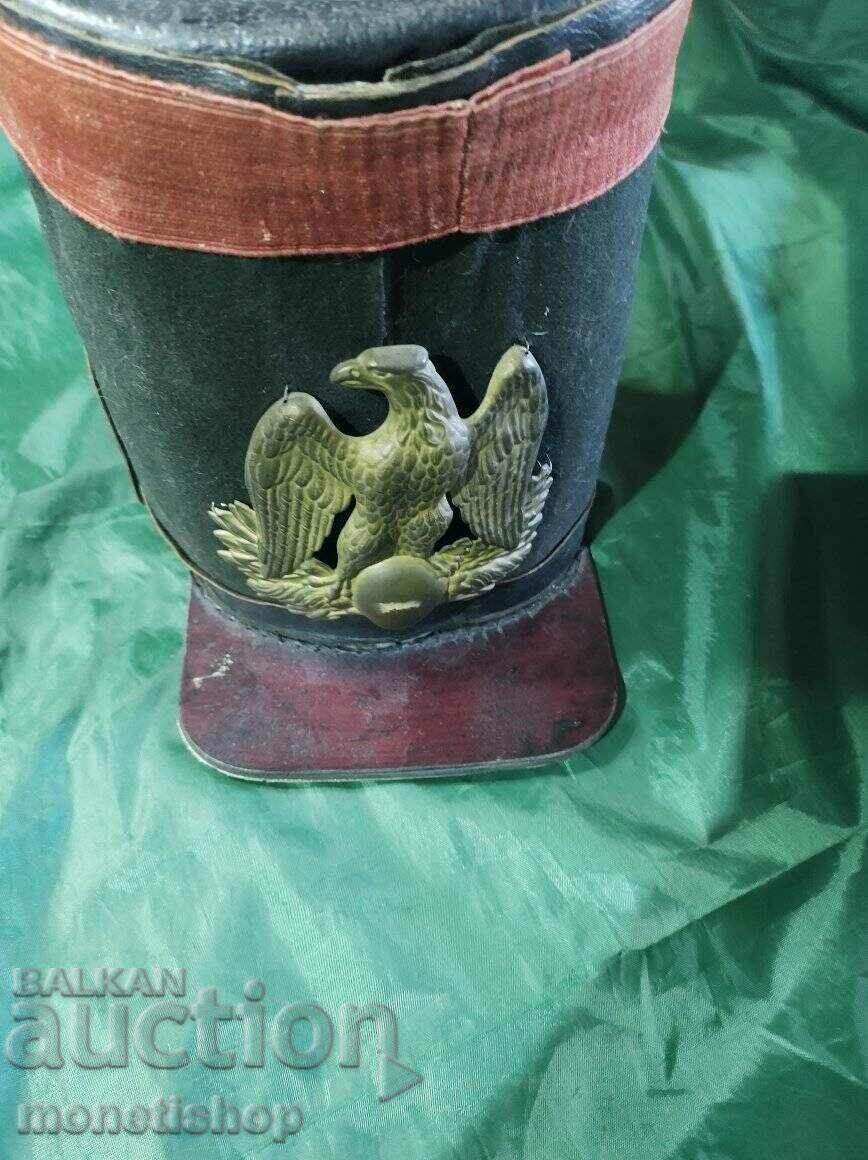 Very old hat made of genuine leather and metal cockade