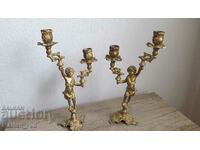 A pair of antique bronze candlesticks