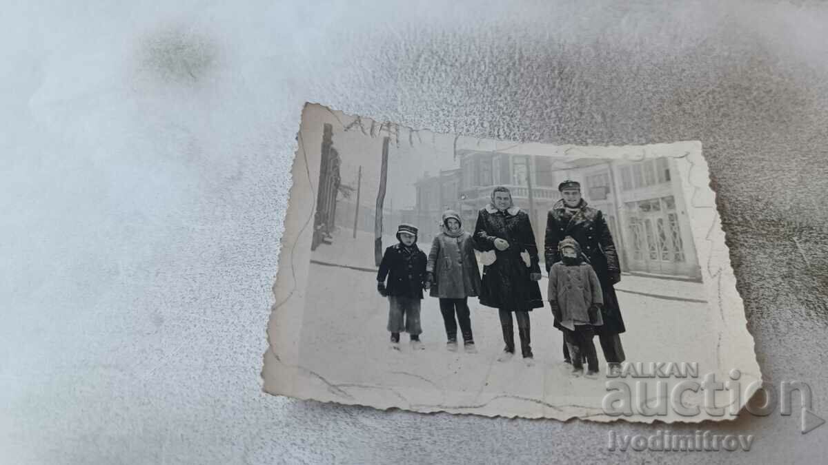 Ms. Karnobattu Man, woman and three children on the street in winter