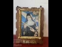 A wooden panel with an image of Saint Rita