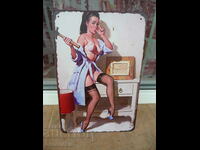 Metal plate erotica girl hangs a picture on the wall hammer
