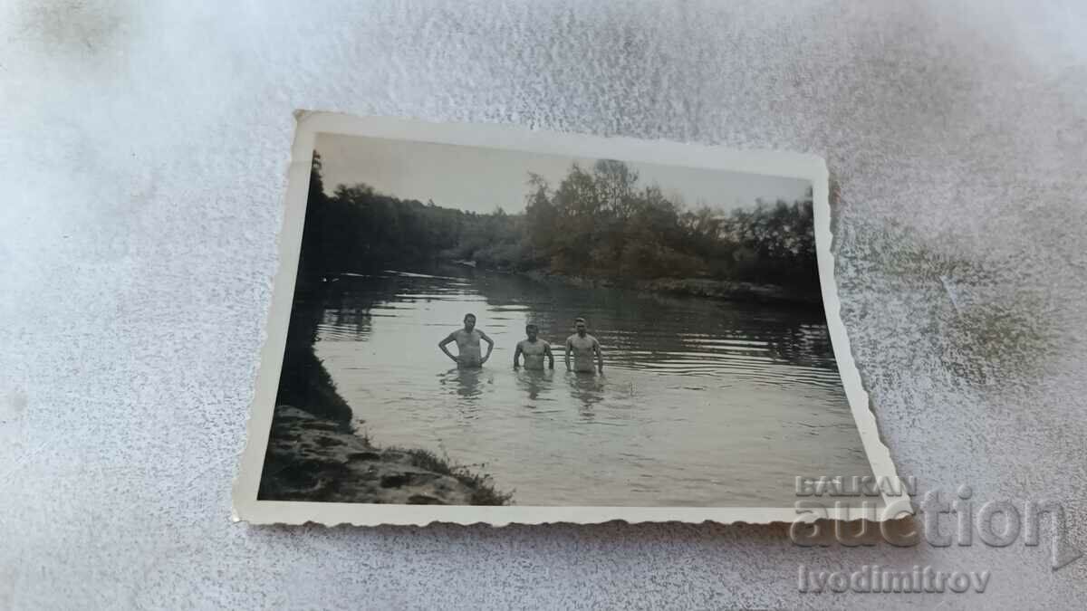 Photo Three men in the river