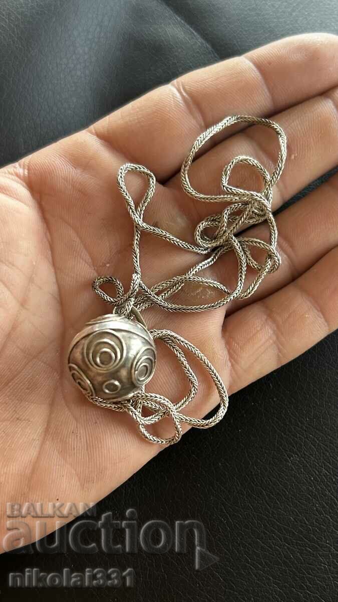 A large solid silver necklace with a jingle pendant!