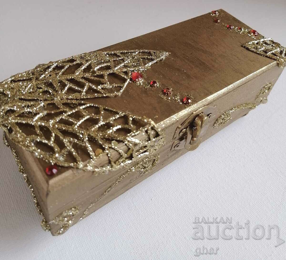 Gilded wooden jewelry box with gilded ornaments.