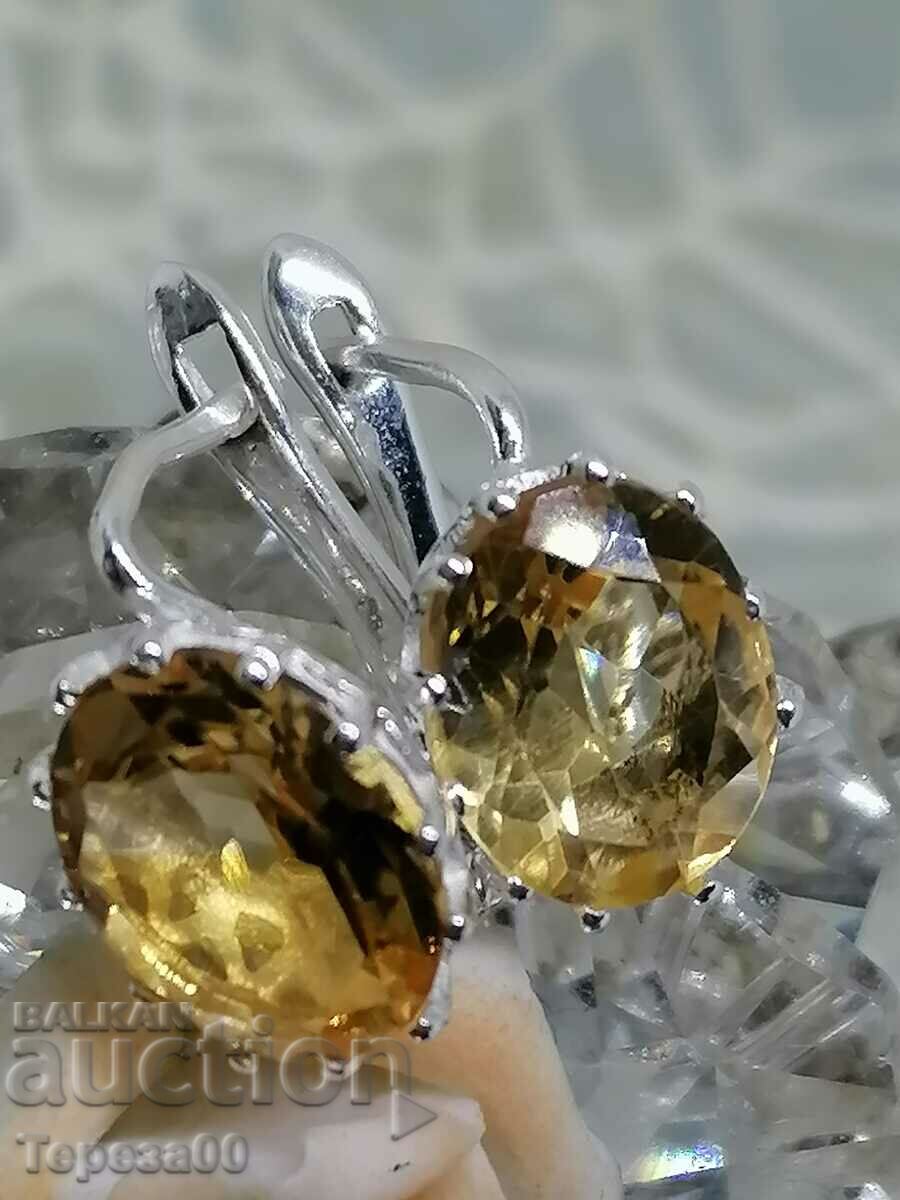 It adorns silver earrings with citrine