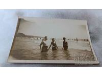 Photo Two men and a young girl in the sea