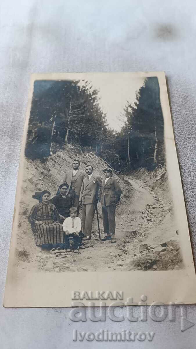 Photo Lying Men two women and a boy on the road