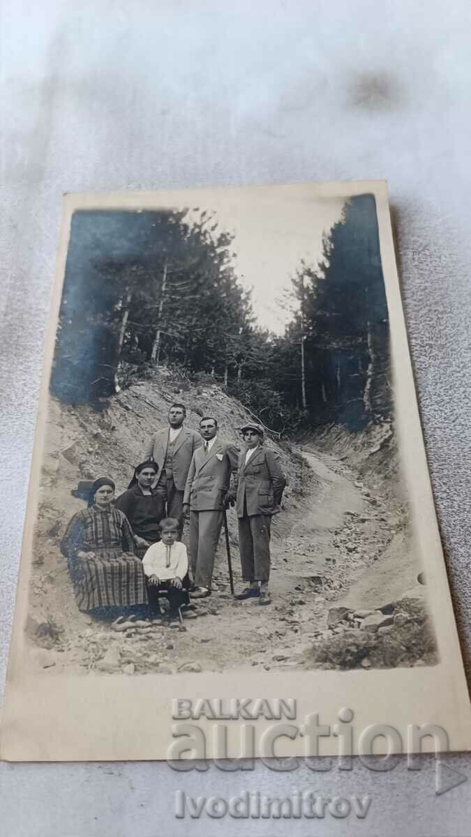 Photo Lying Men two women and a boy on the road
