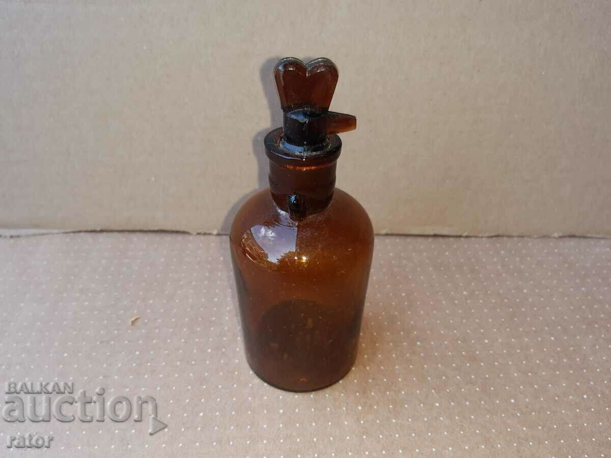 Delivery of Old apothecary bottle with dropper. Pharmacy glassware Delivery of Old apothecary bottle with dropper. Pharmacy glassware