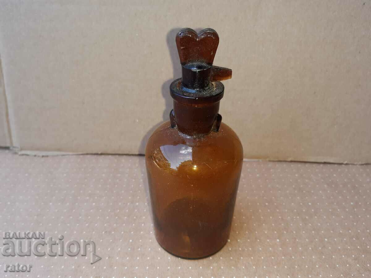 Delivery of Old apothecary bottle with dropper. Pharmacy glassware Delivery of Old apothecary bottle with dropper. Pharmacy glassware