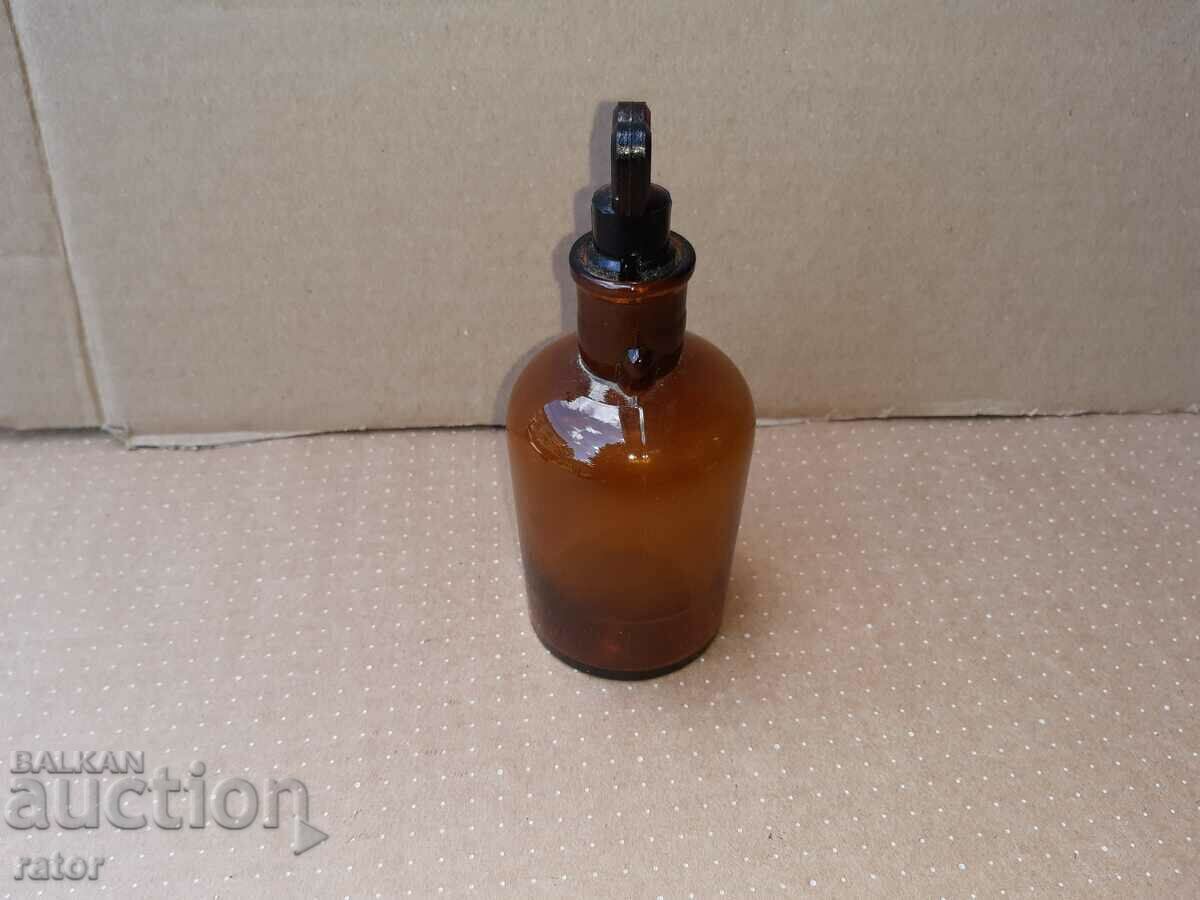 Delivery of Old apothecary bottle with dropper. Pharmacy glassware Delivery of Old apothecary bottle with dropper. Pharmacy glassware