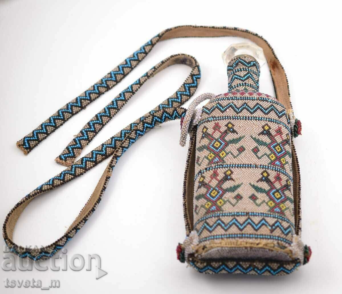 Auction Glass bottle encrusted with glass beads, late 19th century Auction Glass bottle encrusted with glass beads, late 19th century