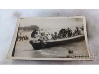 Photo Girls and boys on a boat on the seashore