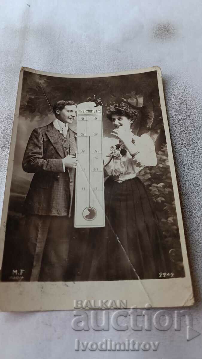 P K Άνδρας και νεαρή γυναίκα δίπλα σε ένα τεράστιο θερμόμετρο 1909