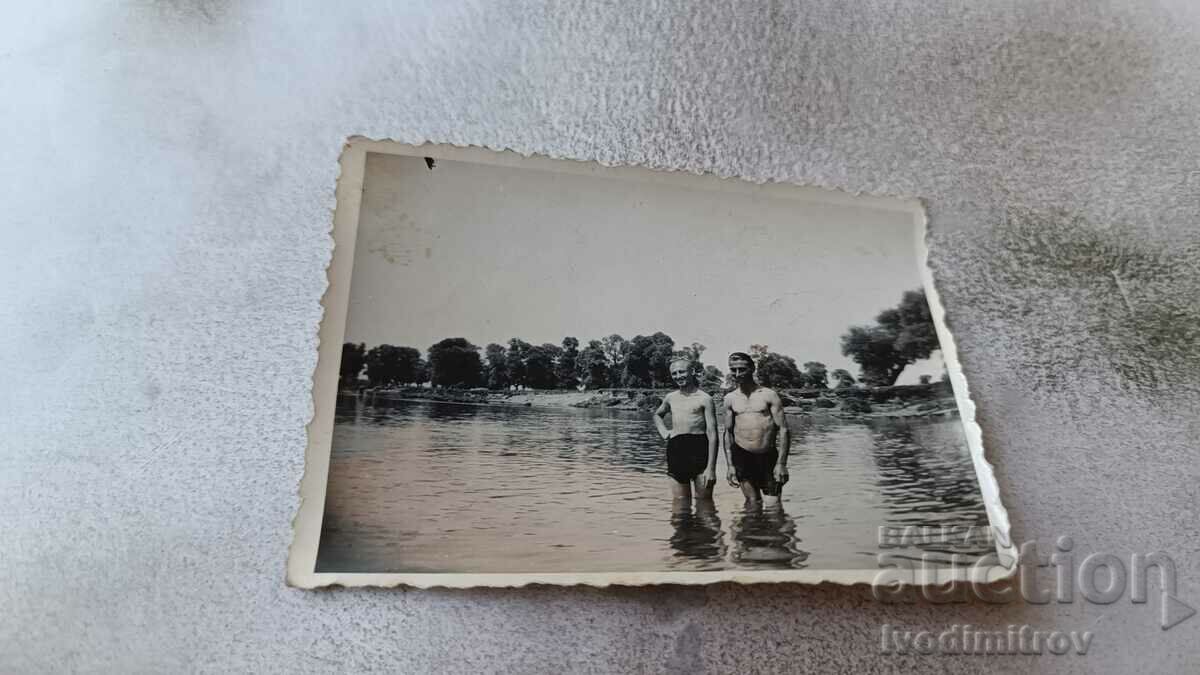 Photo Two boys in retro swimsuits in the river