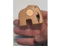 Wooden elephant with a 1 euro cent coin