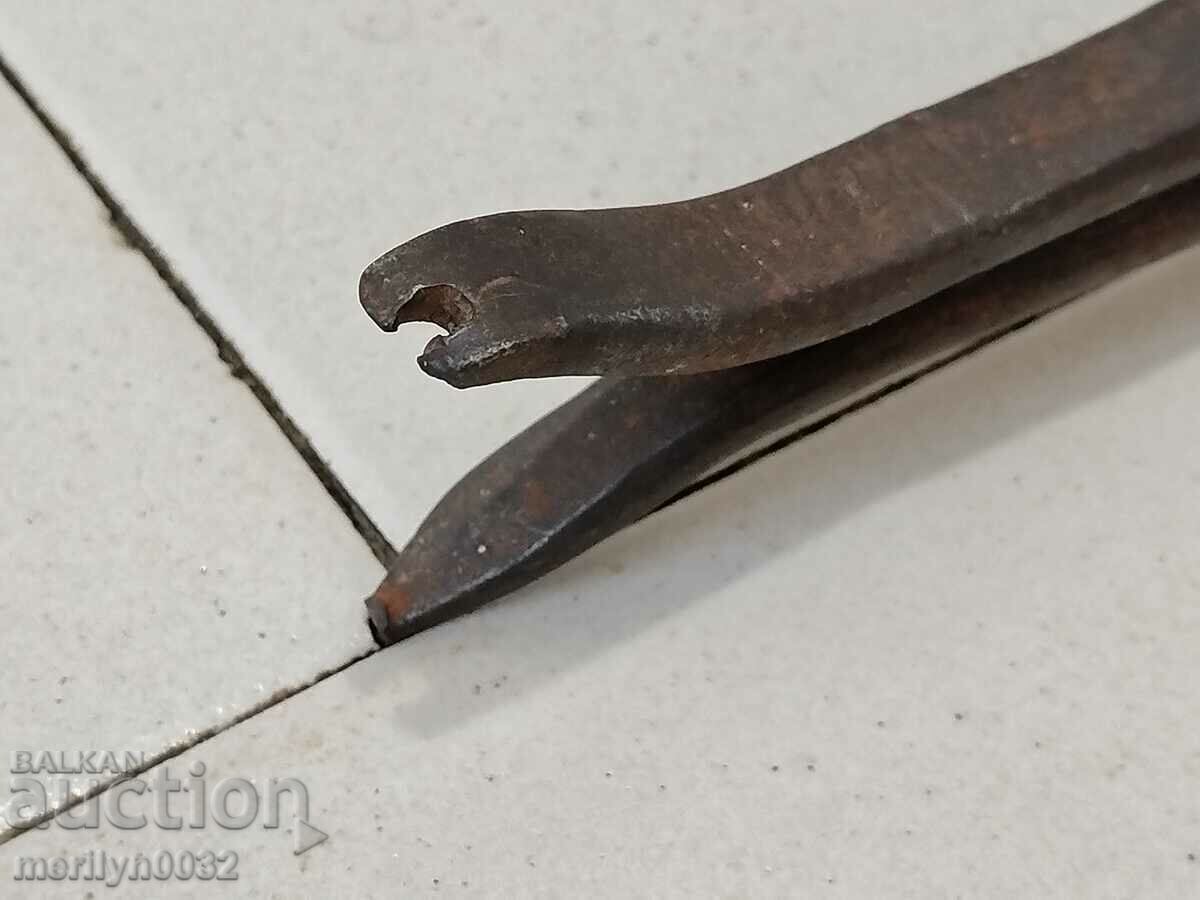 Auction  Old blacksmith's tongs, shingles, wrought iron