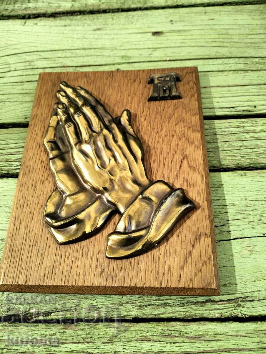 The begging hands panel in wood and brass