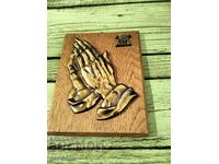 The begging hands panel in wood and brass