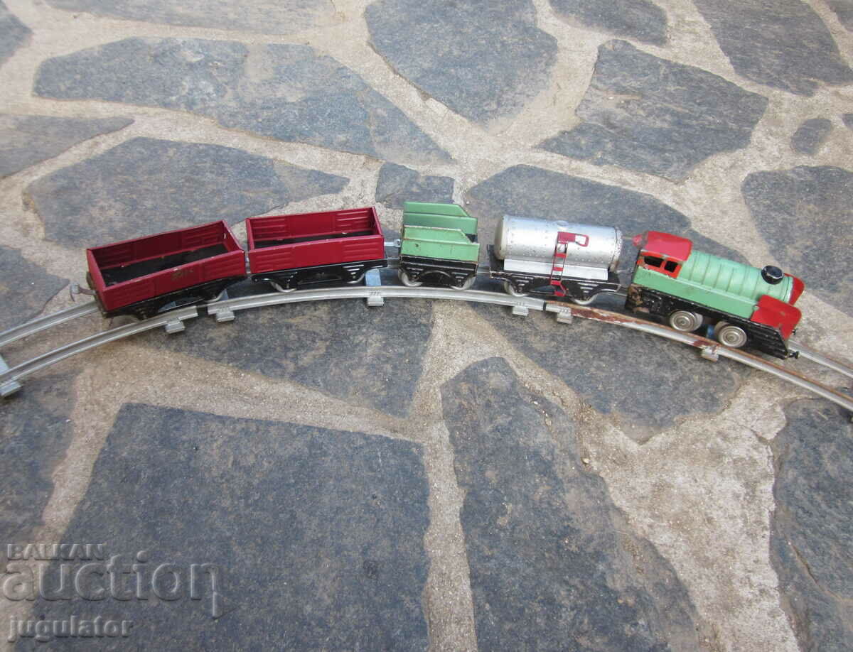 Auction old metal mechanical toy locomotive with wagons and rails Auction old metal mechanical toy locomotive with wagons and rails