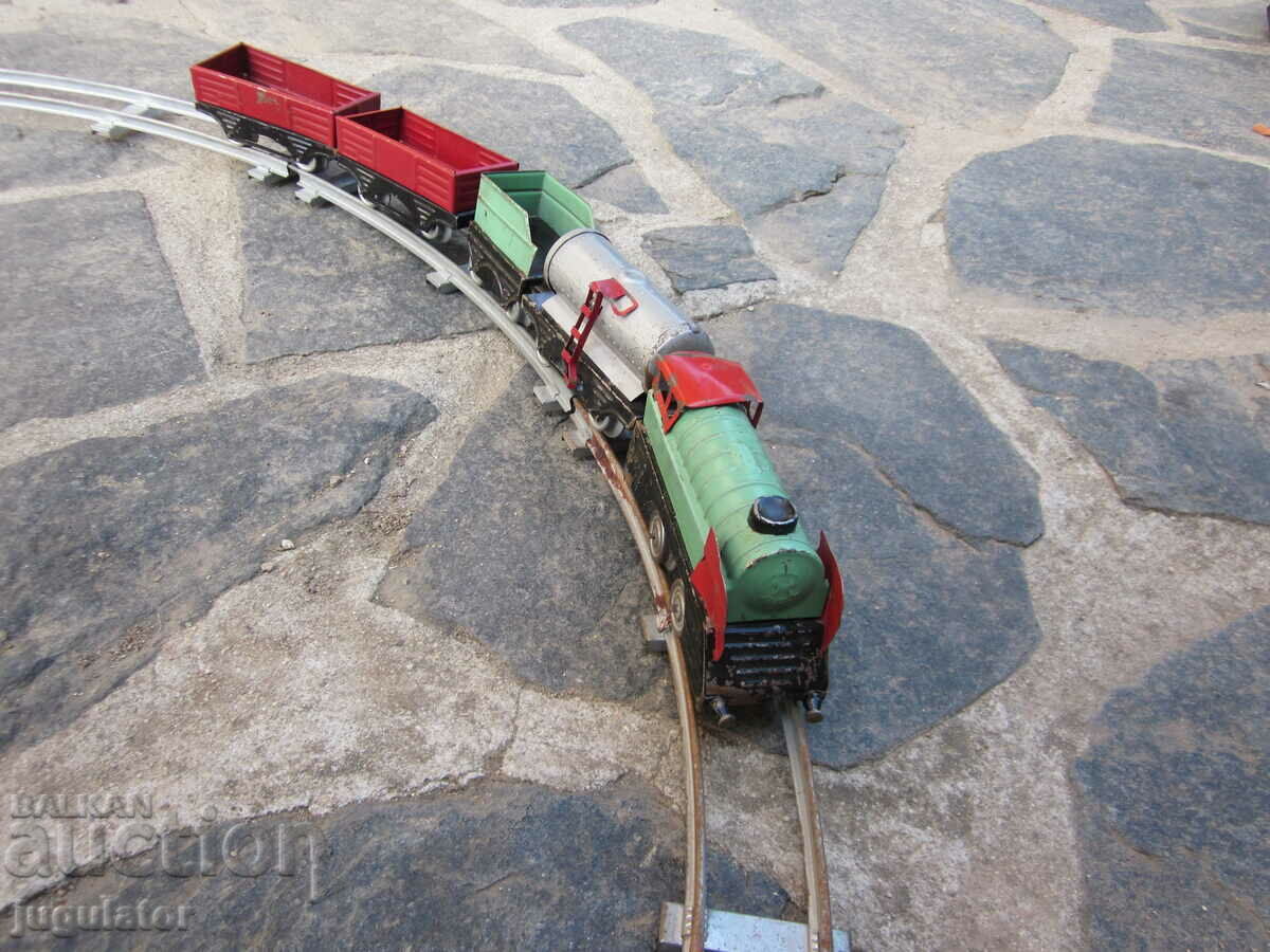 Delivery of old metal mechanical toy locomotive with wagons and rails Delivery of old metal mechanical toy locomotive with wagons and rails