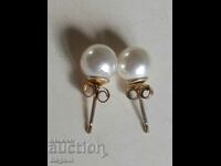 Branded silver earrings with pearls.