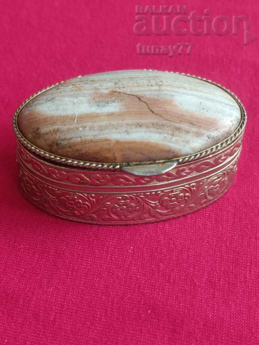 A small bronze box with an onyx lid