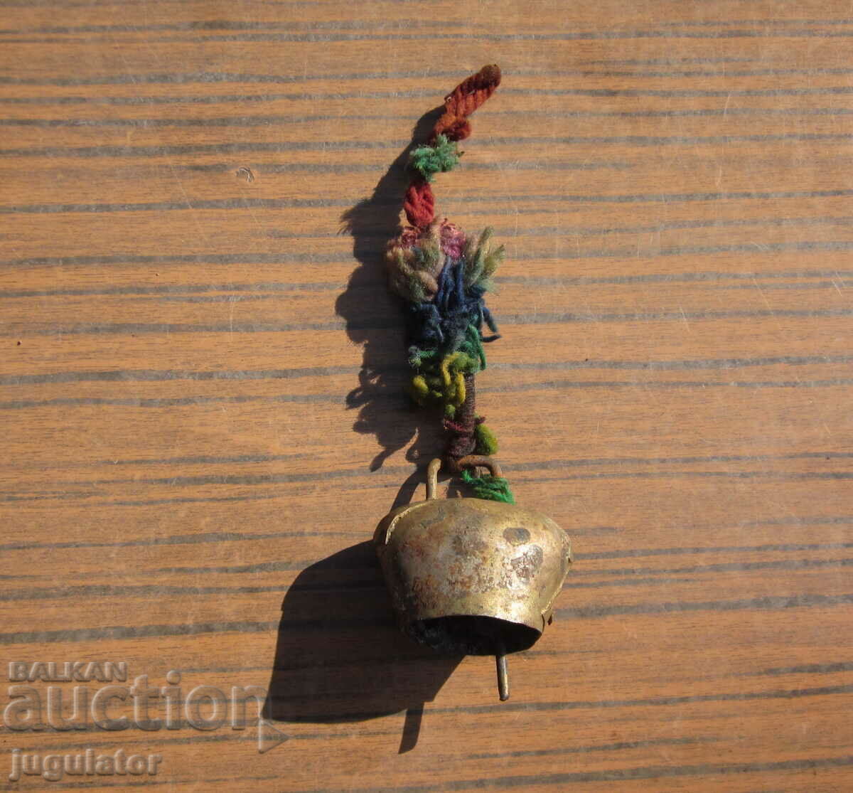 old Bulgarian folk clapper bell with woolen ribbon