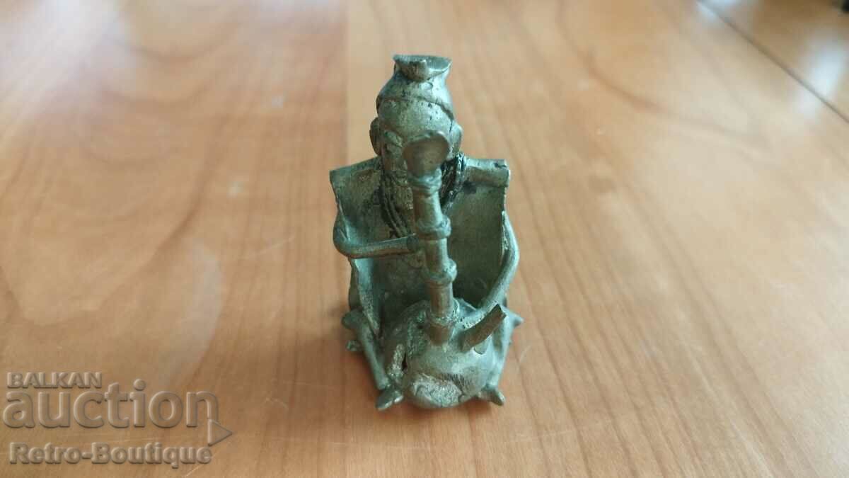 Old metal figurine, musician