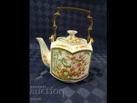 Porcelain teapot with bronze handle