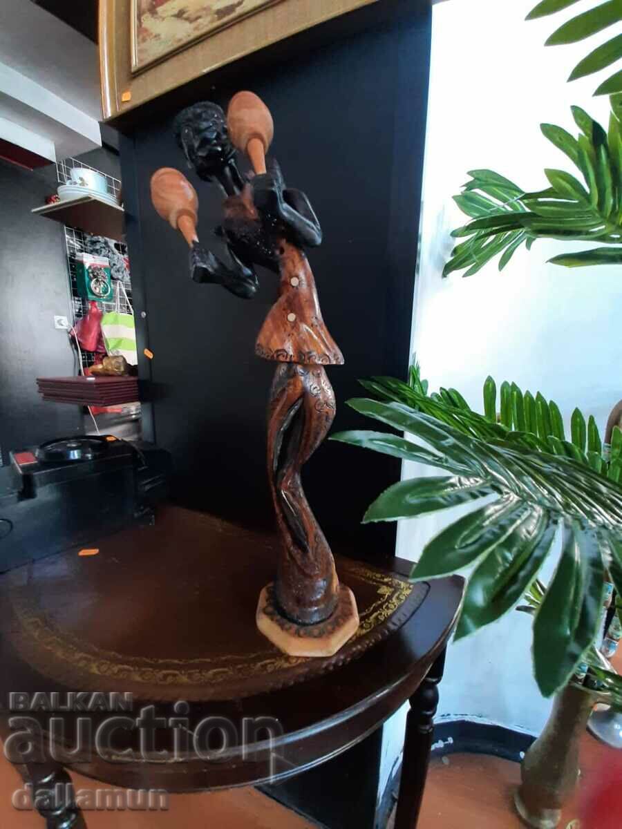 Auction wooden figurine of an African musician Auction wooden figurine of an African musician