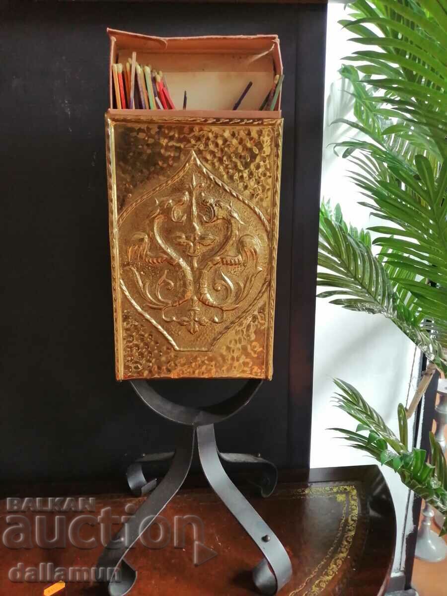 antique metal matchbox on iron stand