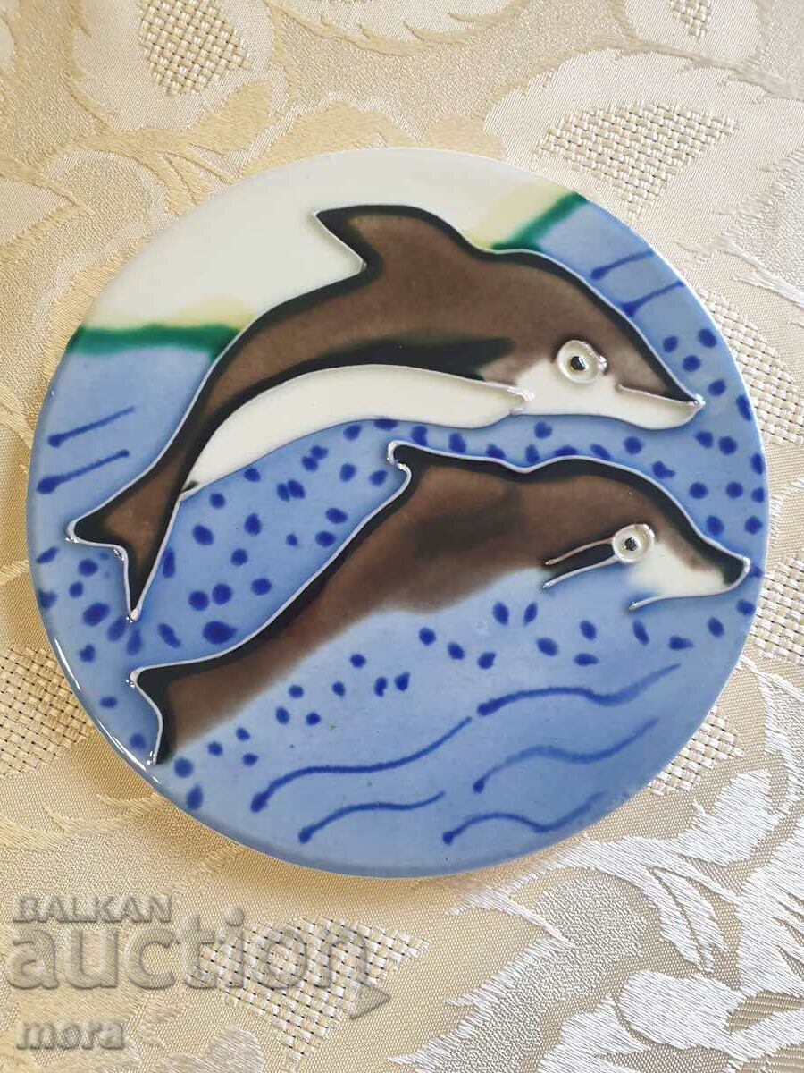 Porcelain tile with a pair of dolphins