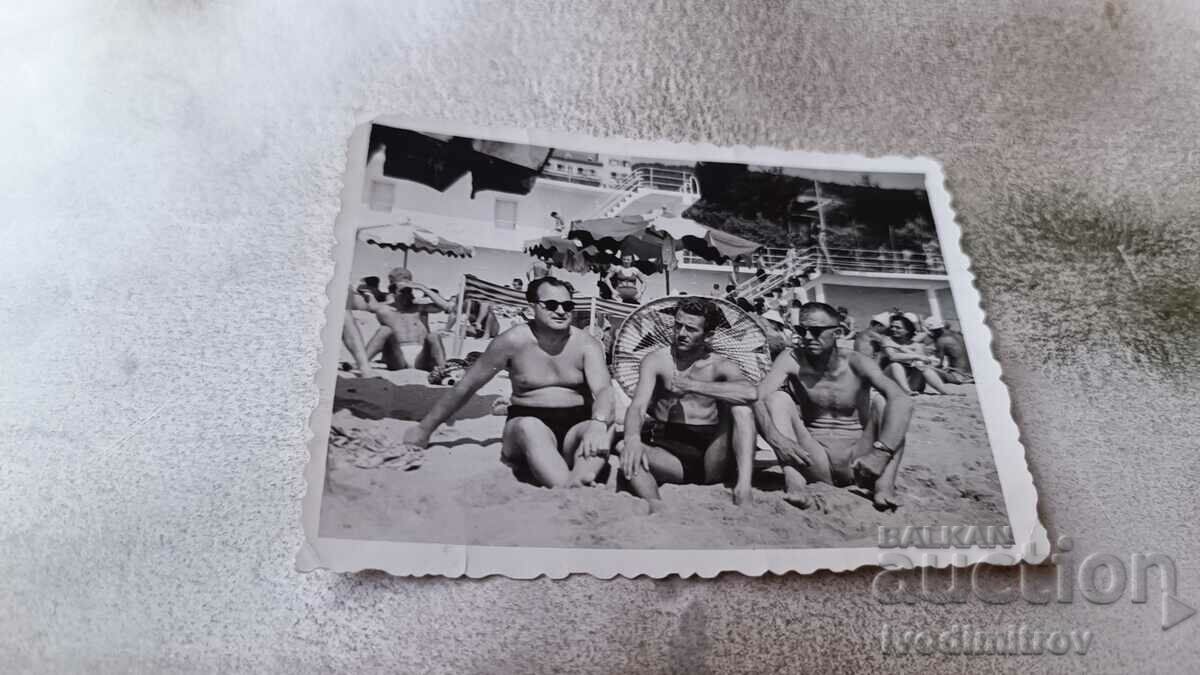 Photo Three men on the beach