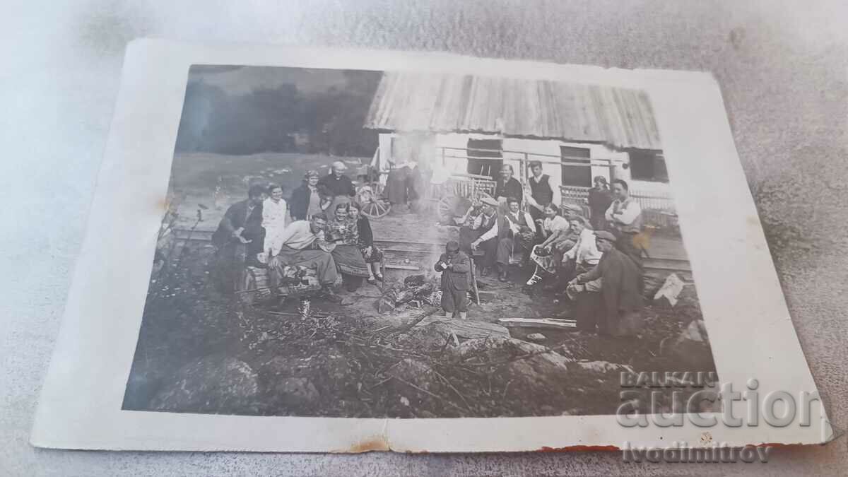 Picture Men women and children around a lit fire