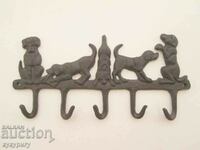 Old metal cast iron wall hanger with cast iron dogs