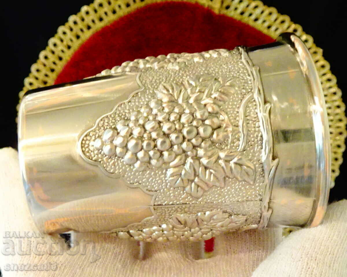 Auction  Silver-plated wine glass, embossed grapes.