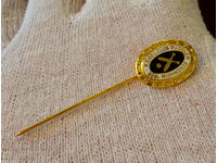 Gold plated tie pin.