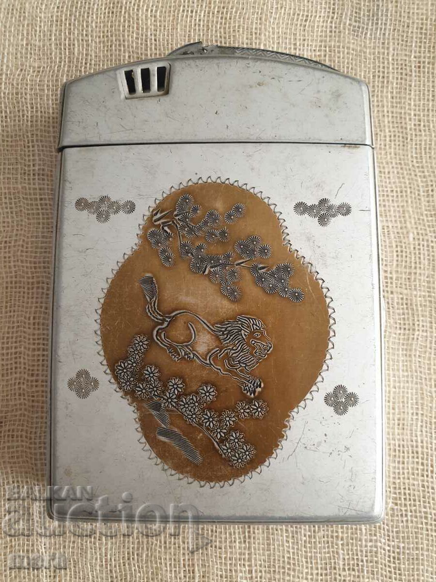 An old snuffbox with a built-in petrol lighter