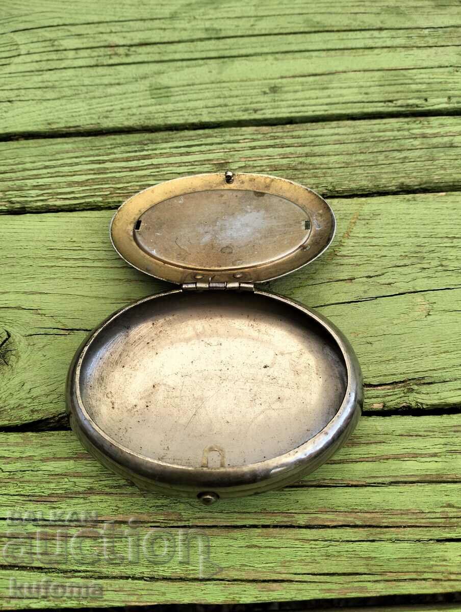 An old snuff box or pocket ashtray