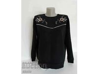 Black quilted blouse with two flower ornaments, size M