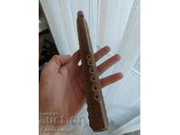 A carved wooden wind instrument