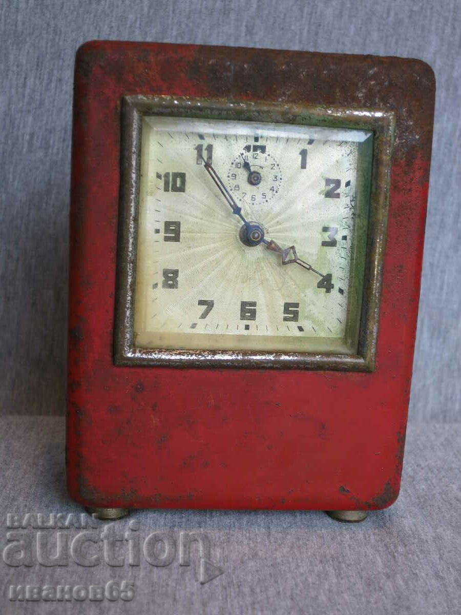 old alarm clock with money box