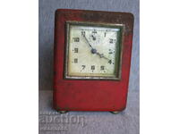 old alarm clock with money box